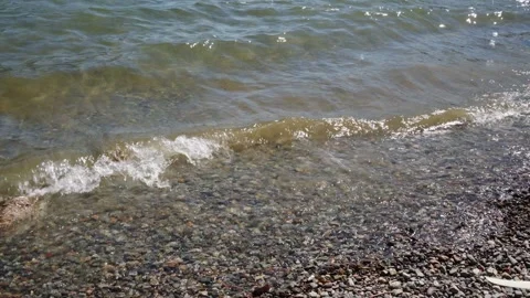 Gentle Waves Lapping Pebbled Shoreline Stock Footage 255399199