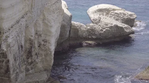 Gentle waves lapping rocks near Rosh HaNikra grottoes Stock Footage 83718202