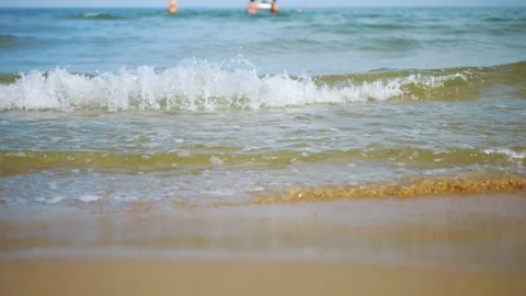 Gentle waves lapping on the sandy shore of Sunny Beach, Bulgaria in 4K slow.. Stock Footage 294895358