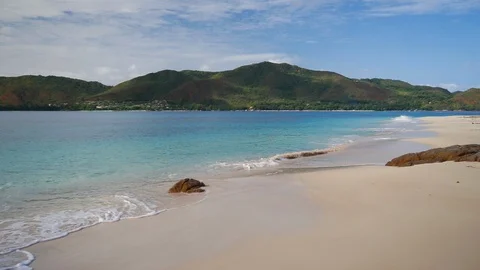 Gentle waves lapping the shore of a tropical beach Stock Footage 101659657