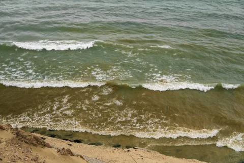 Gentle Waves Lapping on the Shoreline with Soft Sands and Coastal Serenity .. Stock Photos