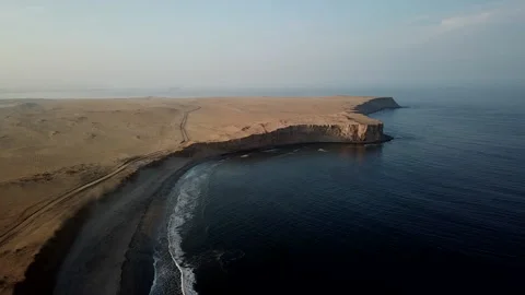 Gentle waves meet Eroded steep cliffs in Paracas Reserve, Peru - Aerial Stock-Footage 154097584