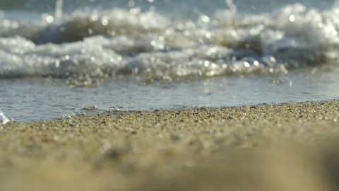 Gentle waves on a pebble beach Stock Footage 212779722