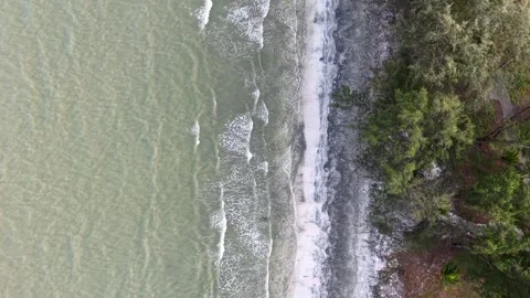 Gentle waves roll onto the sand Stock Footage 333045538