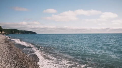 Gentle waves rolling onto a pebble beach on the Black Sea coast in Tuapse Stock Footage 325738478