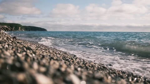 Gentle waves rolling onto a pebble beach on the Black Sea coast in Tuapse Stock Footage 325738571