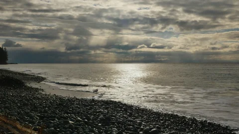 Gentle waves rolling onto pebblebeach w sound Stock Footage 262484738