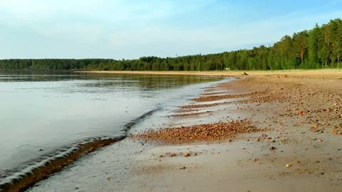 Gentle Waves Rolling onto Sandy Beach in Summer Evening Stock-Footage 329360393