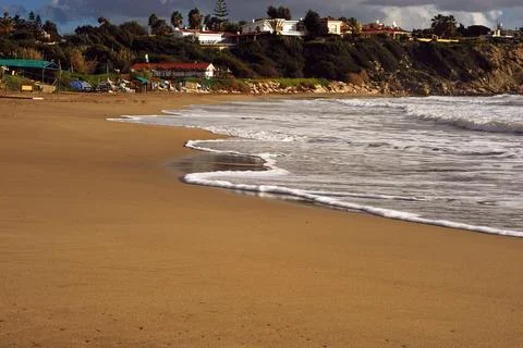 Gentle waves rolling onto a sandy beach Stock Photos