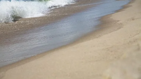 Gentle waves rolling onto sandy sea shore under natural daylight with smoot.. Stock Footage 344332082