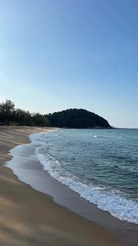 Gentle Waves on Sandy Beach with blue evening sky Stock Footage 340869652