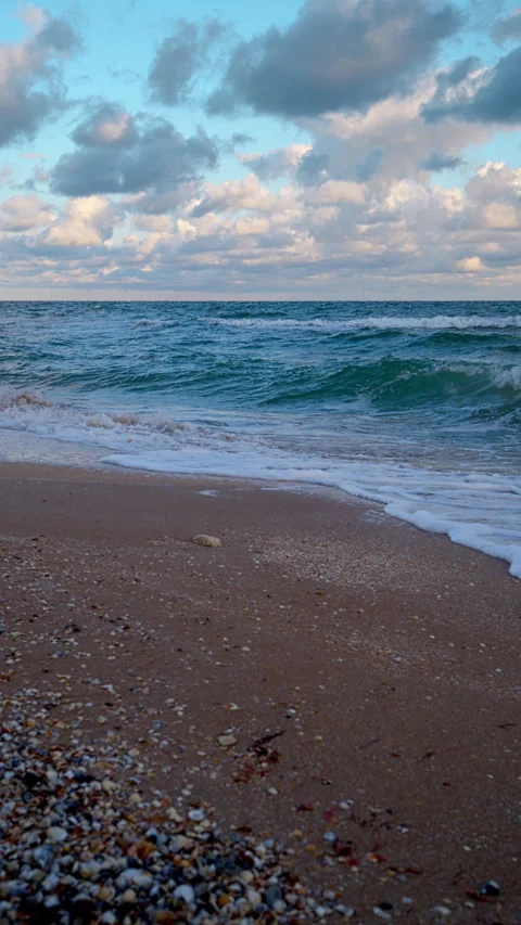 Gentle Waves on a Sandy Beach at Dawn with Cloudy Sky Stock Footage 312752101