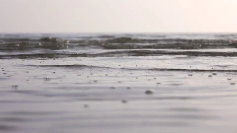 Gentle waves on a sandy beach Stock Footage 233990556