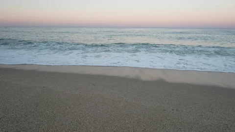 Gentle Waves on Sandy Beach at Sunset Stock Footage 282927593