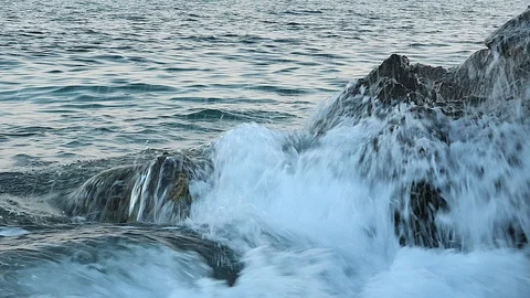 Gentle waves sea. Sand and rock on beach Stock Footage 104900853