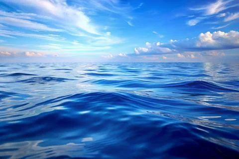 Gentle waves of the sea surface with the reflection of the blue sky. Stock Photos
