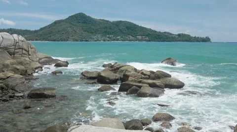 Gentle Waves Splash over a Rocky Tropical Beach Stock Footage 56494084