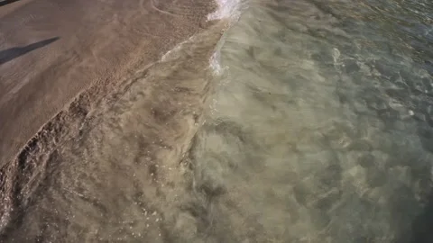 Gentle waves wash on sandy beach in Portocolom, Cala Marsal beach, Mallorca Stock Footage 325846412