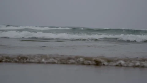 Gentle waves washing ashore on a cloudy day Video stock 300581043