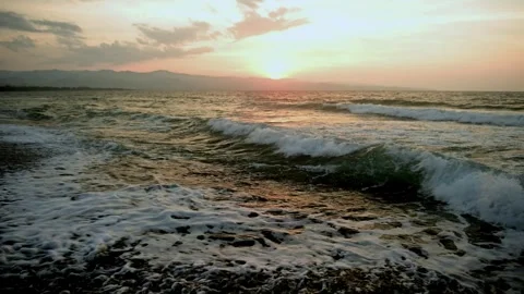 Gentle waves washing ashore at sunset, Cyprus beach, relaxing loop Stock Footage 326816907
