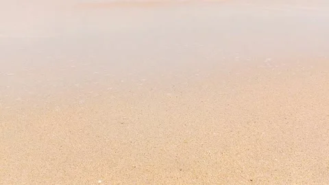 Gentle waves washing onto a sandy beach Stock Footage 346335913