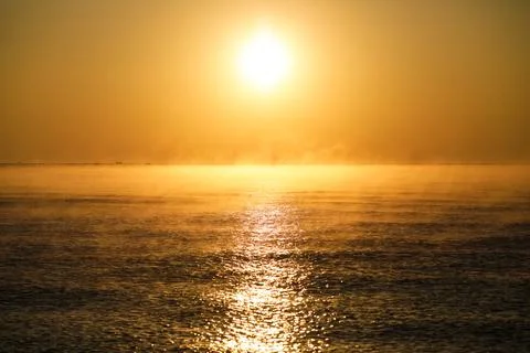 Gentle waves while the sun is rising over the Black Sea in the Obzor resort i Stock Photos
