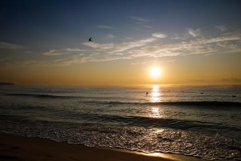 Gentle waves while the sun is rising over the Black Sea in the Obzor resort i Stock Photos