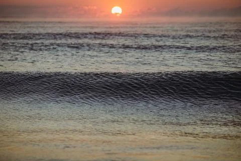 Gentle waves while the sun is rising over the Black Sea in the Obzor resort i Stock Photos