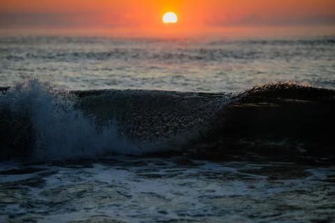 Gentle waves while the sun is rising over the Black Sea in the Obzor resort i Stock Photos