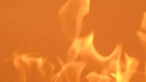 Gentle yellow flames on a orange background. Slow-motion video of fire and Stock Footage 248008723
