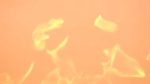 Gentle yellow flames on a orange background. Slow-motion video of fire and Stock Footage 250134207