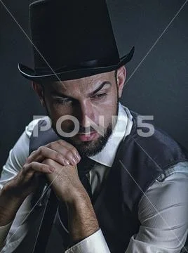 The gentleman. Dramatic male portrait with classic light and retro dress Stock Photos