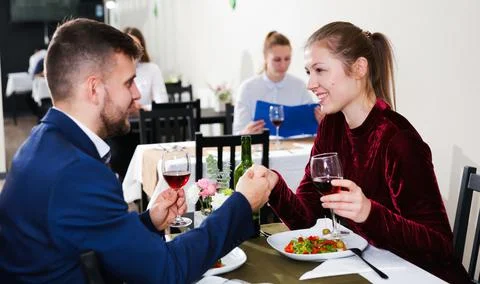 Gentleman with elegant woman are having dinner in luxury restaurante Stock Photos