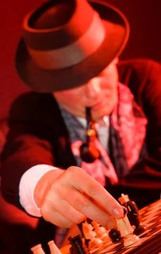 Gentleman in hat playing chess Stock Photos