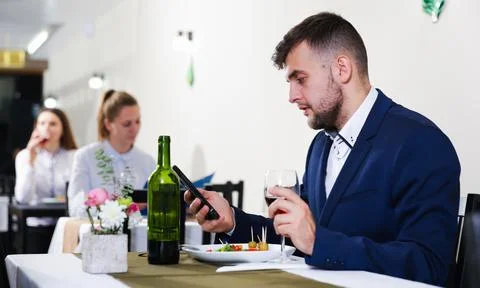 Gentleman is having dinner in luxury restaurante Stock Photos