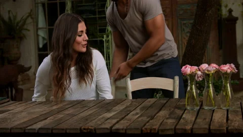 Gentleman man pulling chair from table for date in cafe. Stock Footage 199633020