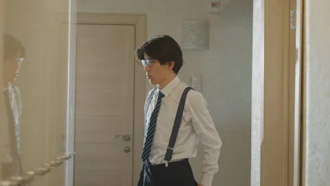 Gentleman readies for presentation. Professional young man adjusts attire Stock Footage 342057581