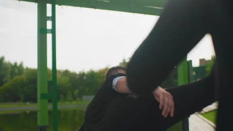 Gentleman shields strike with serene composure by lakeside, Young martial artist Stock Footage 330957482