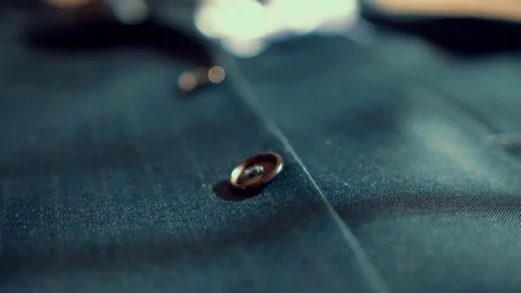 Gentleman's suit jacket close up to buttons. Cam moves to the right Video stock 69976869