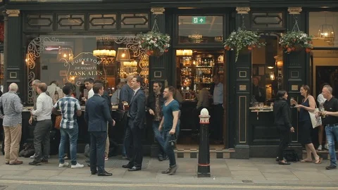 The gentlemen drinking beer in front of the pub and talking, London, UK Stock Footage