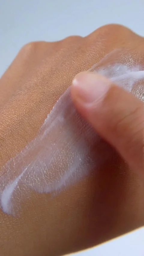Gently applying moisturizing cream to back of hand. Top close up view. Stock Footage 338231437