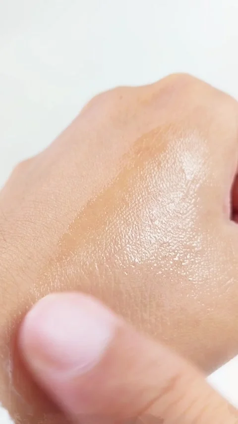 Gently applying moisturizing serum evenly onto hand skin. Close up skincare.. Stock Footage 336238702