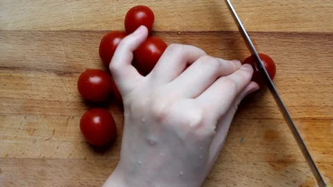 Gently chop the tomatoes. Woman's hands cutting tomatos. Stock Footage 129569815