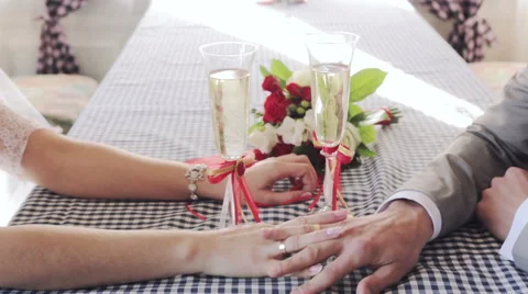 Gently connected hands of a newly-married couple with wedding rings on a finger Stock Footage 58357309