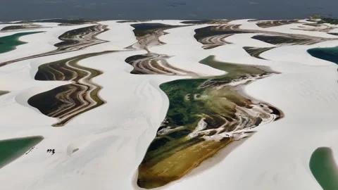 Gently Gliding Across Sculpted Dunes and Lagoon Channels in Lençóis Maranhenses Video stock 342444259