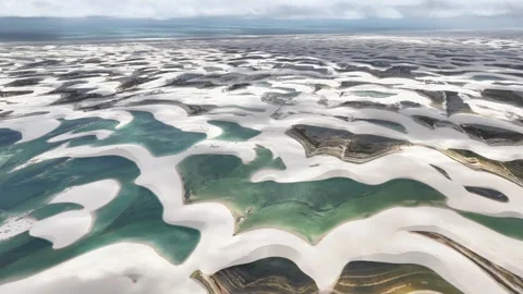 Gently Moving Over Emerald Lagoons and White Dune Ribbons in Lençóis Maranhenses Video stock 342442098