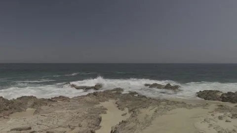 Gently moving over rocky beach out ot sea Stock Footage 279774194