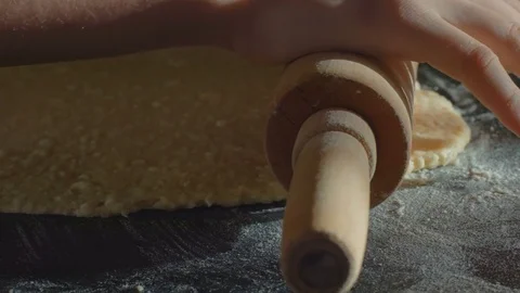 Gently rolling the dough with a rolling pin Stock Footage 84651562