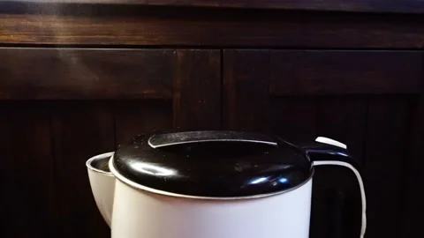 Gently Steaming Electric Kettle, High-Angle CU, Mood Spotlight, HD Stock Footage 219770703