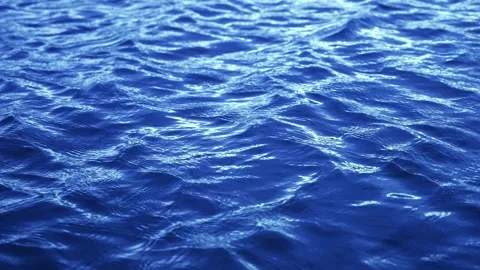 Gently textured ocean surface shimmering with sunlight in relaxing hypnotic Stock Footage 314408308